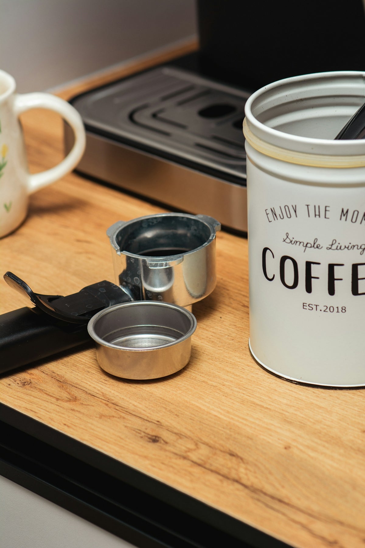 a cup of coffee sitting on top of a wooden table