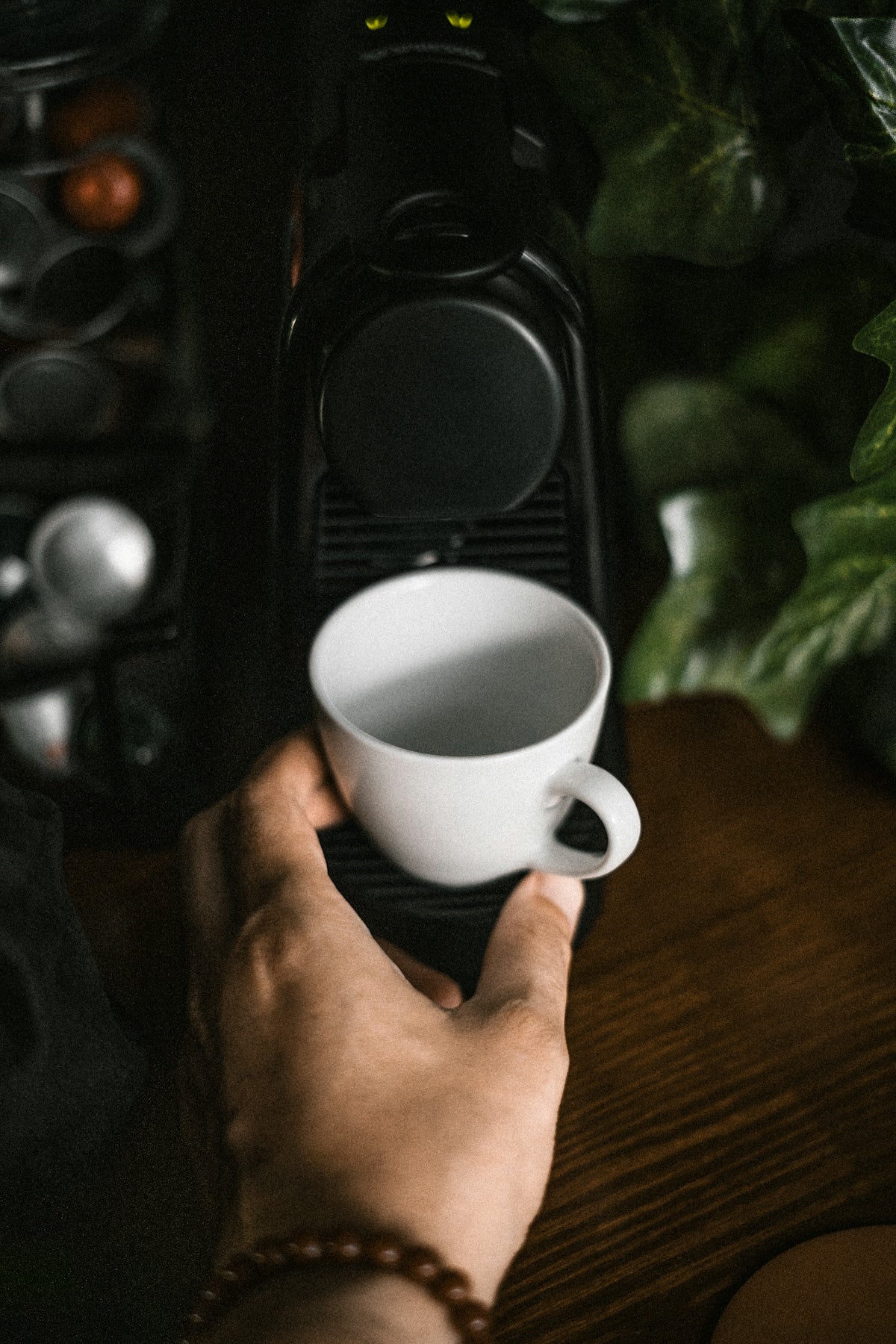 a person is holding a cup of coffee