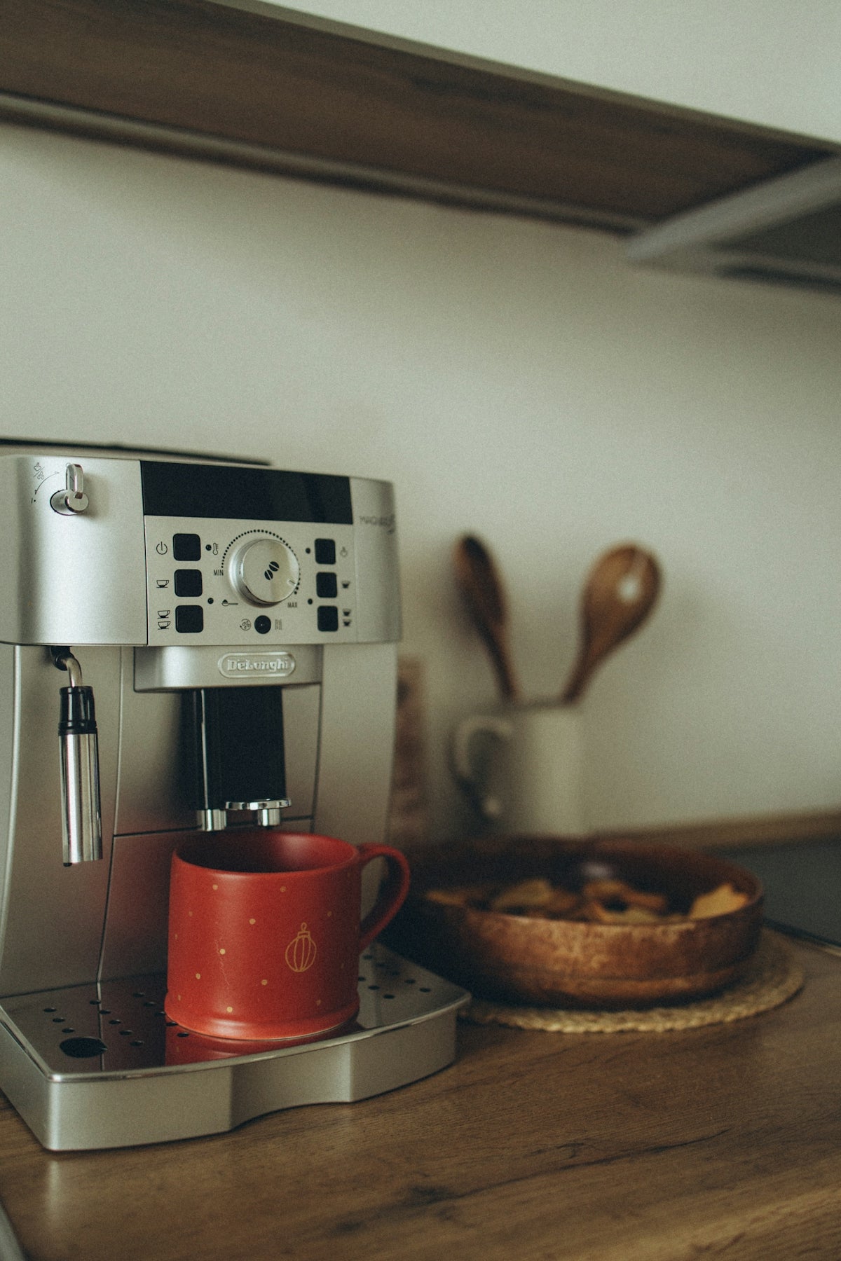 A coffee maker sitting on top of a wooden counter