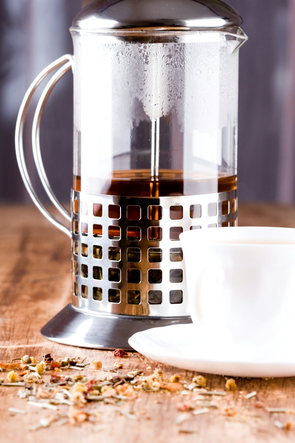 A coffee pot and a cup on a table