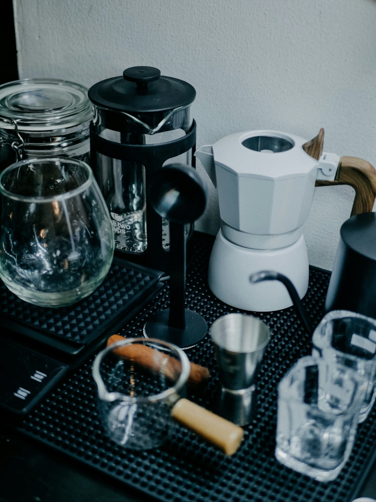 A black tray topped with a coffee maker and cups
