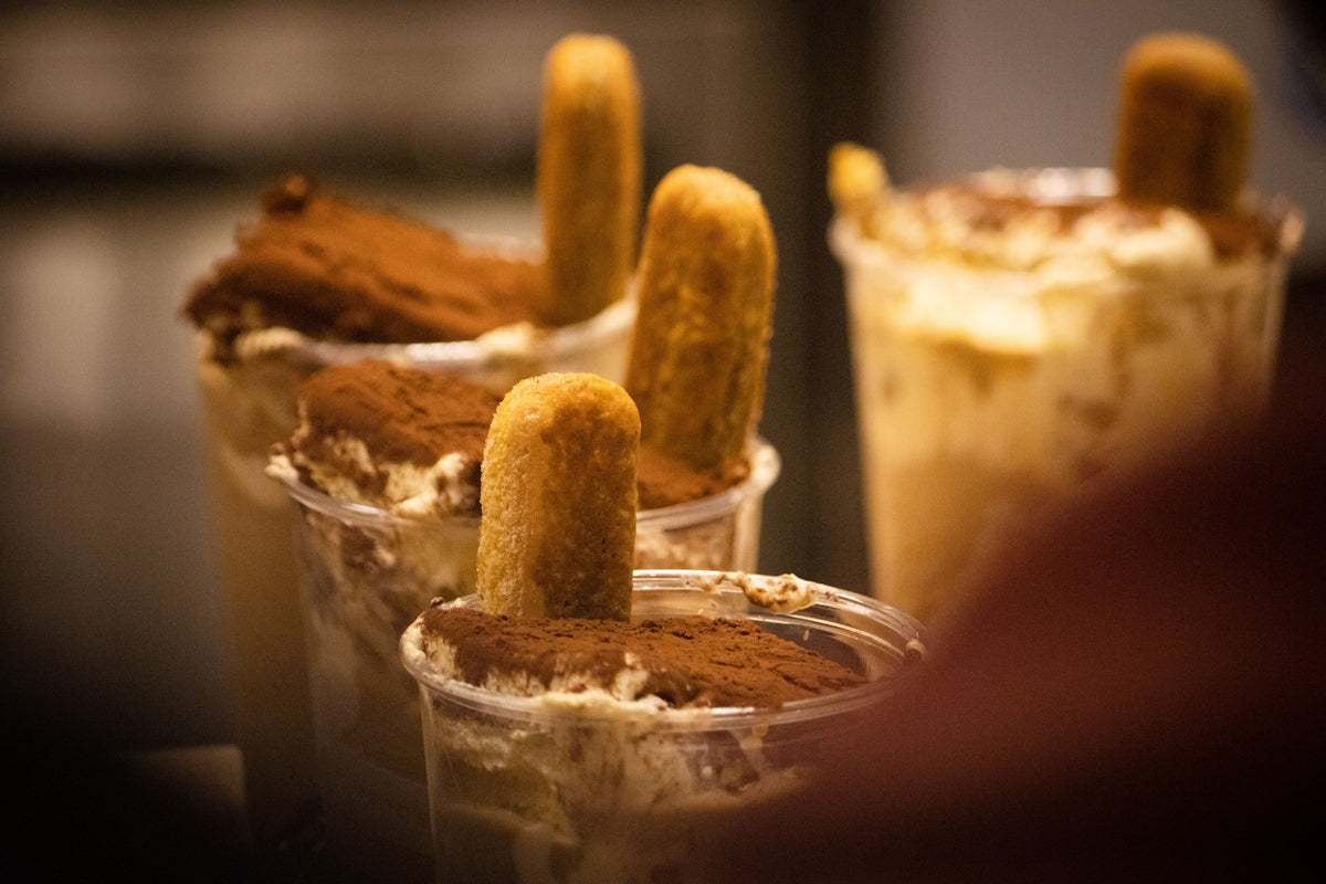 Tiramisu desserts in clear cups with ladyfingers